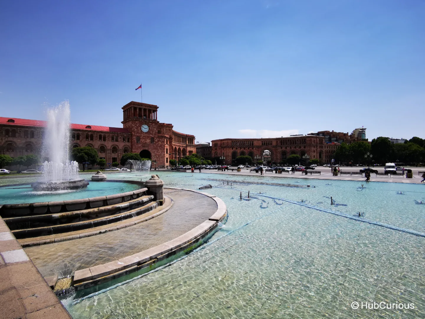 Singing fountains of Republic Square in Yerevan, with the pink tuff Government House and its clock tower behind