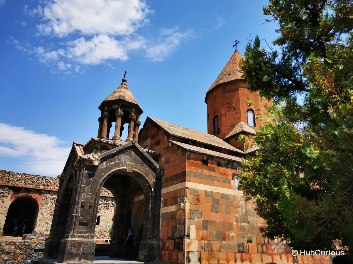 The belfry and red stone church of Khor Virap monastery against a clear blue sky